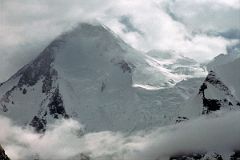 
The next morning we started our trek from Shagring Camp to Gasherbrum Base Camp in mostly cloudy weather. After 30 minutes we reached Gasherbrum Corner at the junction of the Upper Baltoro Glacier with the tributary Abruzzi Glacier. Gasherbrum I and Gasherbrum I South lie straight ahead. Gasherbrum I (8080m) is the 11th highest mountain in the world. Gasherbrum I was first climbed by July 5, 1958 by Americans Pete Schoening and Andy Kauffman. Gasherbrum I South (7069m) was first climbed by Maurice Barrard and Georges Narbaud via the Southwest Ridge in July 1980 on their ascent of Gasherbrum I
